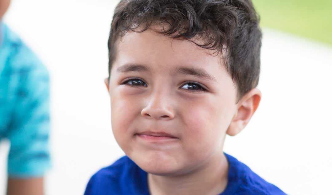 A little boy looking at the camera