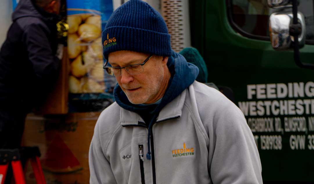 Voluneteer giving out turkeys