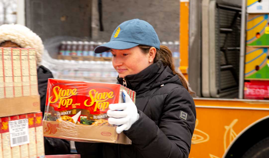 volunteer carrying Stove Top Stuffing boxes