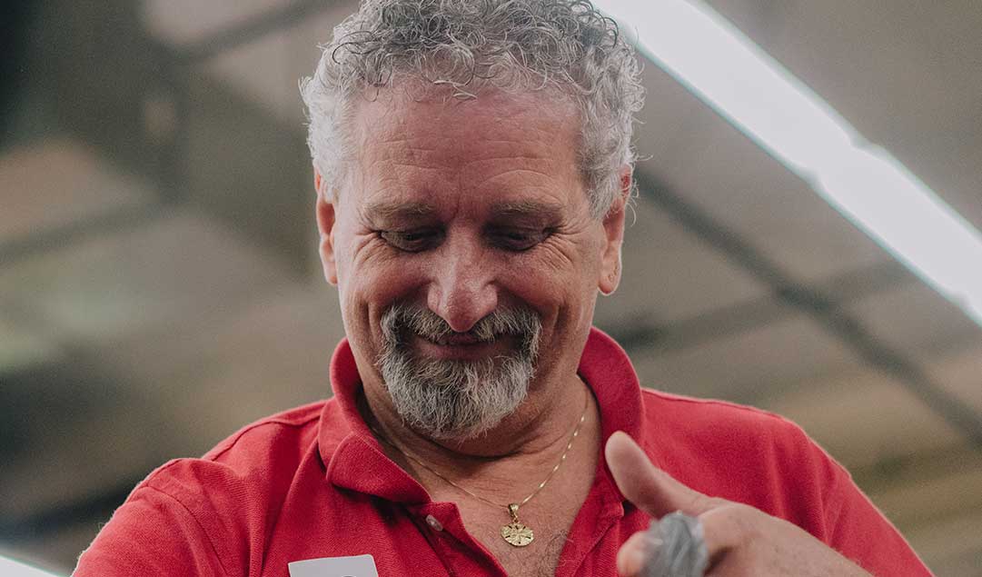 A man in a red shirt bagging groceries